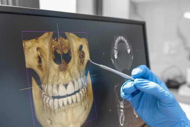 Dentist looking at problem detection by evaluating dental x-ray
