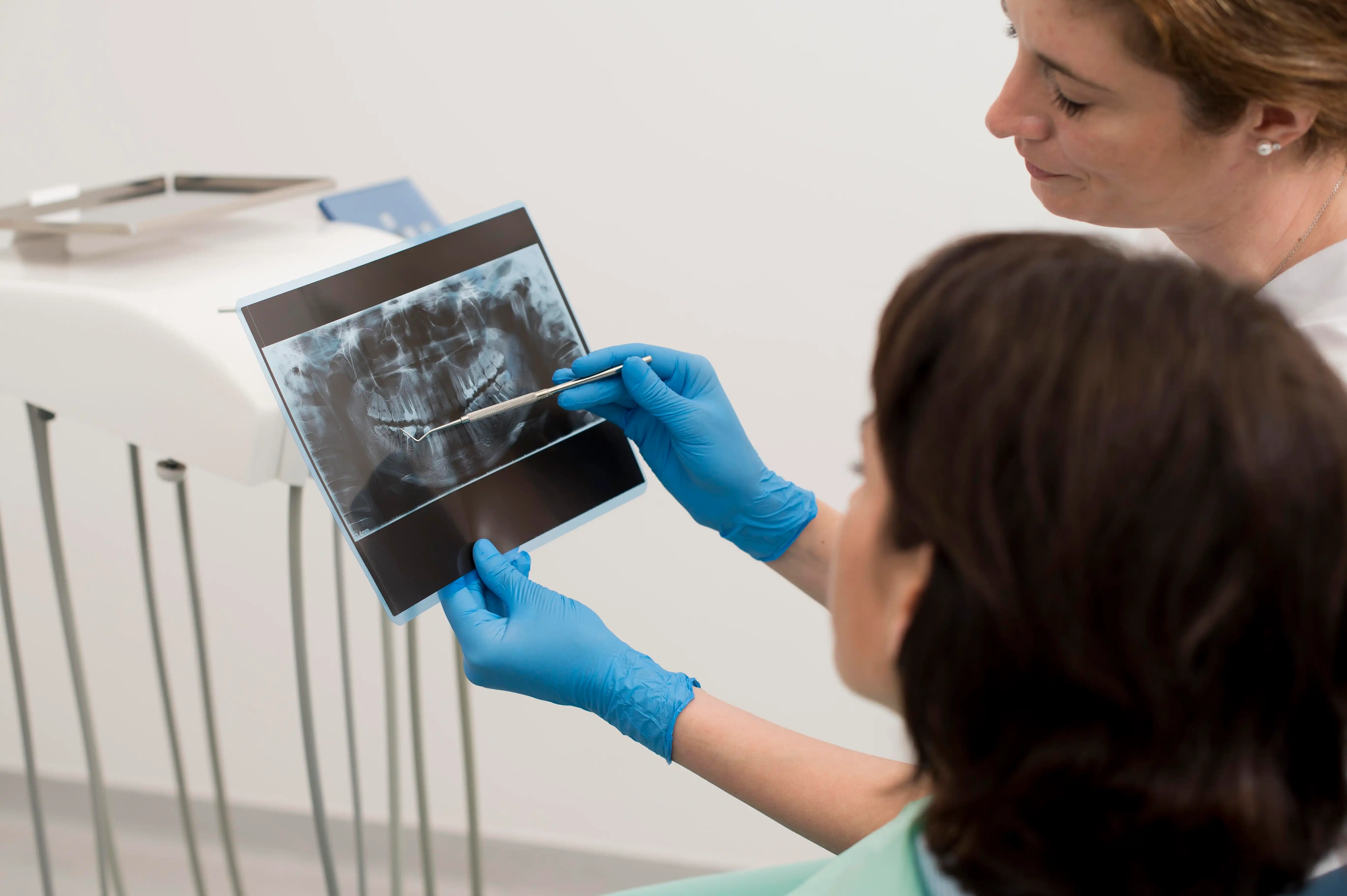 A doctor and patient examining what is panoramic dental x-ray results.